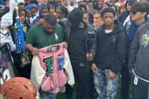 Quan Britton, 23, holds his brother Omarion Wilson’s pink jacket as Jeremiah Wiggins, their u ...