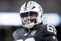 Raiders defensive tackle Adam Butler (69) smiles while warming up before the NFL game against t ...