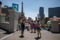 Tourists take photographs along the Strip, Thursday, June 27, 2024, in Las Vegas. (Daniel Jacob ...